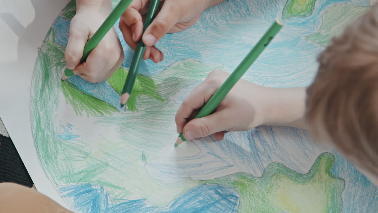 Close Up of Kids Coloring Planet Earth Drawing