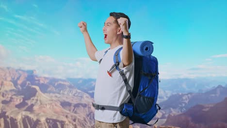 side view of asian male hiker with mountaineering backpack screaming goal celebrating the success while traveling at the top of mountain