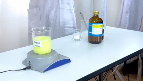 a science experiment demonstrating the iodine clock reaction with vitamin c and starch, observed under consistent lighting in a laboratory setting