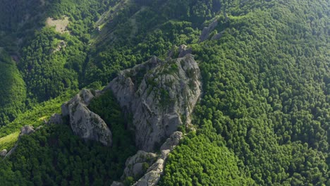 aerial top down shot of karadzhov boulder with green planted mountains in bulgaria