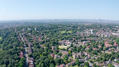 Dolly-forward-drone-shot-over-green-spaces-south-London