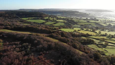 4k aerial shot descending above the rolling hills of culmstock beacon in the blackdown hills of devon england