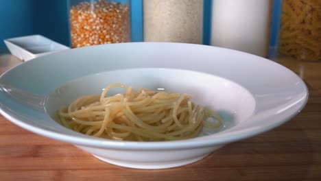 adding freshly boiled pasta to a pasta bowl