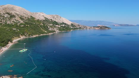 campsite at campig skrila, krk island, stara baska croatia, aerial view of the mountains and coast with boats, beaches and adriatic sea. the seaside rv campmobiles on a summer beautiful coastline