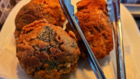 freshly fried, golden-brown, and crispy homemade meat patties, or latvian kotletes, resting on a paper towel on a plate to drain excess oil after cooking - close-up shot