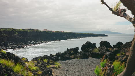 Viewpoint,-camera-moving-forward-unveiling-the-rocky-high-cliffs-of-the-coastline-in-the-Azores-Island,-Portugal