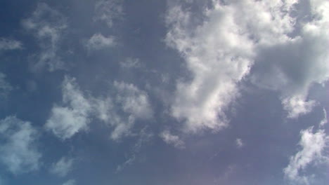 cumulous clouds moving in time-lapsed motion give way to diffuse vapor clouds