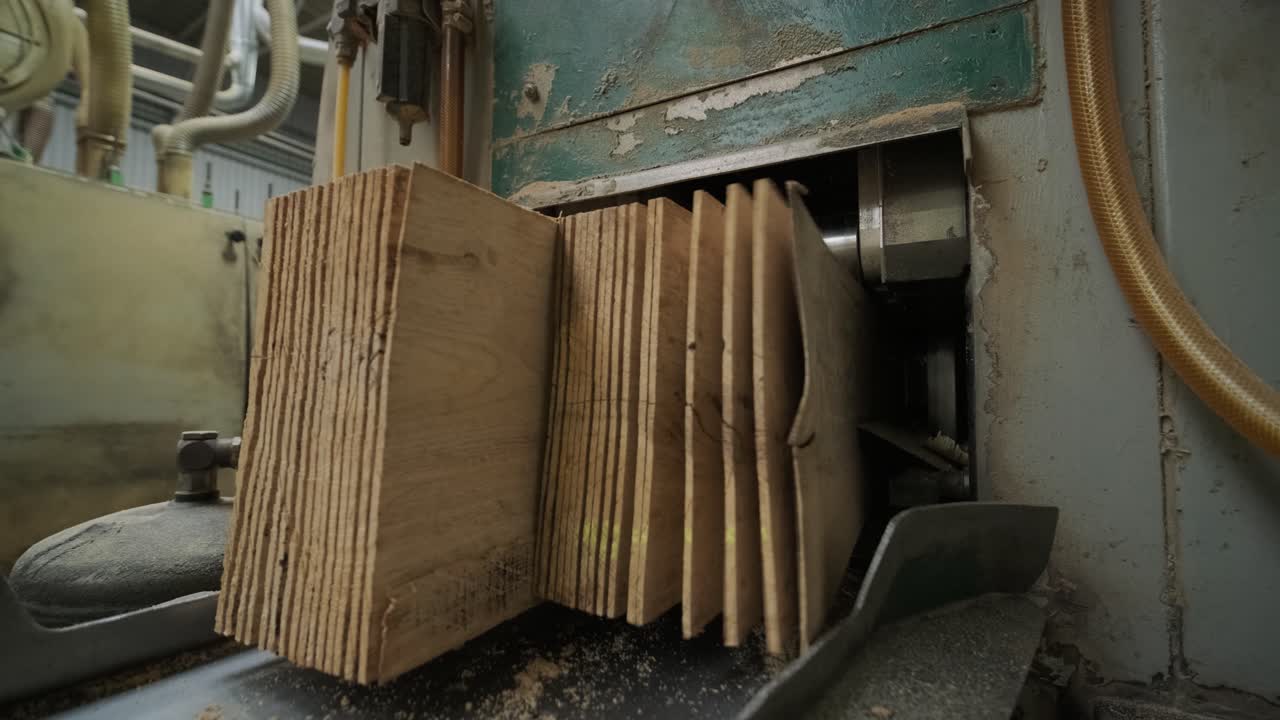 Wooden Planks Moving Through an Industrial Woodworking Machine