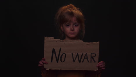 upset poor toddler child girl homeless protesting war conflict raises banner with inscription no war