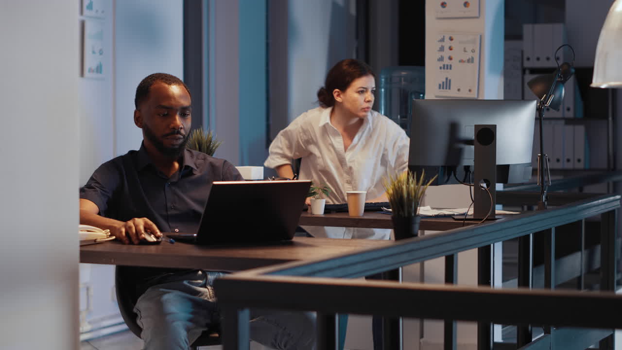 Office employee working on presentation late at night