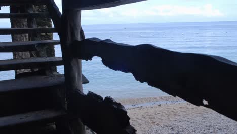 climbing to wooden viewing platform with panoramic seascape view through an old wooden staircase at beach in aloguinsan, cebu, philippines