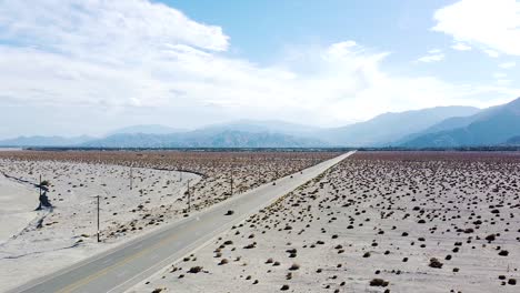 Iconic-American-desert-highway-with-moving-vehicles,-high-angle-drone-view