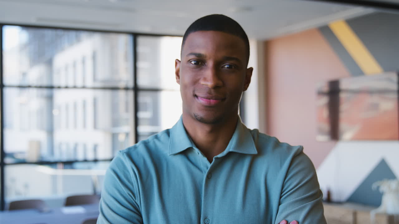 Portrait Of Serious Businessman Standing In Modern Empty Office