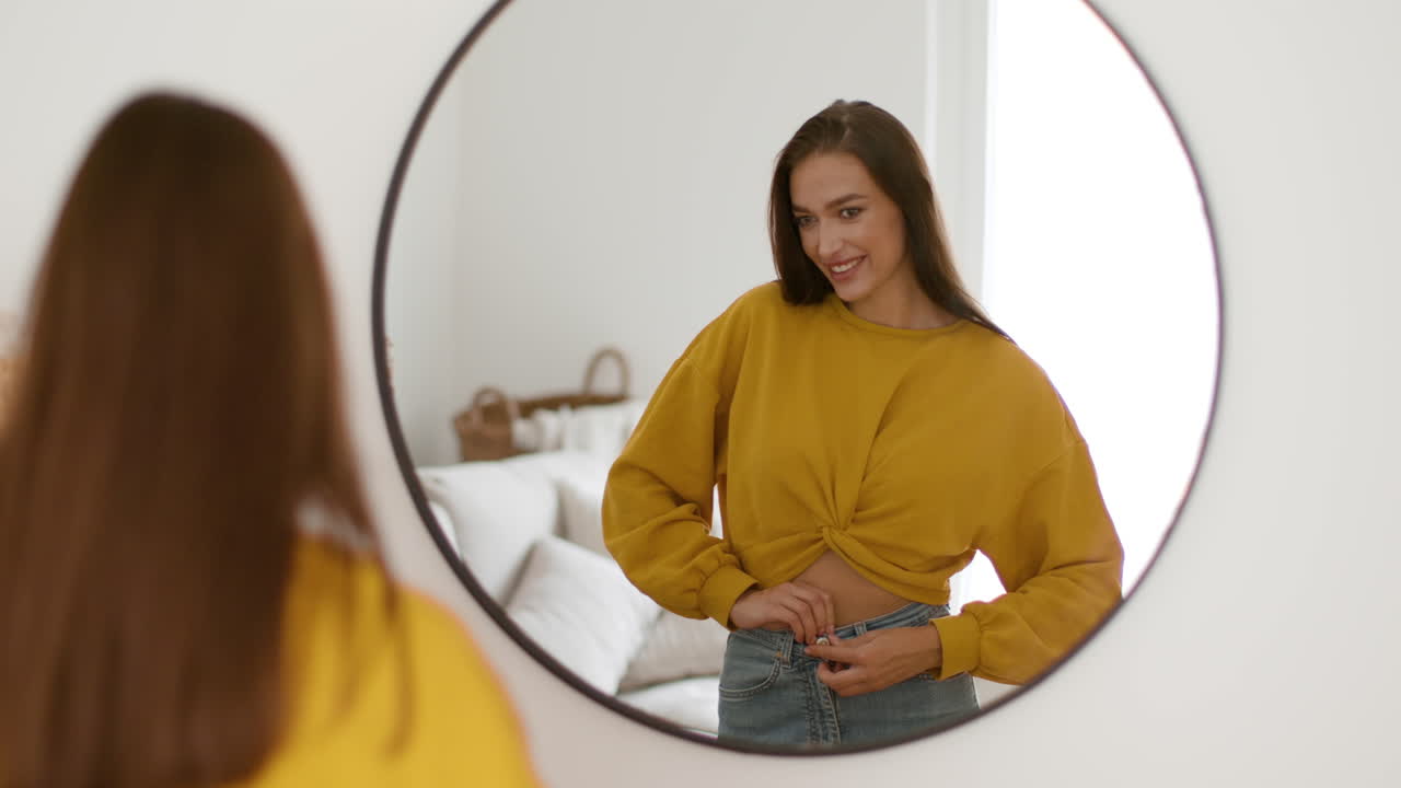 Woman Trying on a Yellow Cropped Top and Jeans