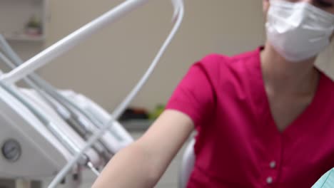 Closeup-view-of-dentist's-hand-preparing-her-instrument-for-utlrasound-cleaning.-Shot-in-4k