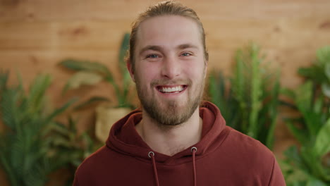 portrait-of-charming-young-man-laughing-happy-enjoying-successful-lifestyle-blonde-caucasian-male-with-long-hair-slow-motion