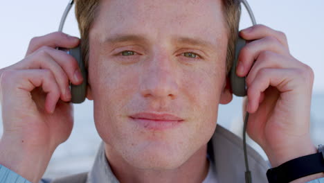 Face,-music-headphones-and-man-at-beach-listening