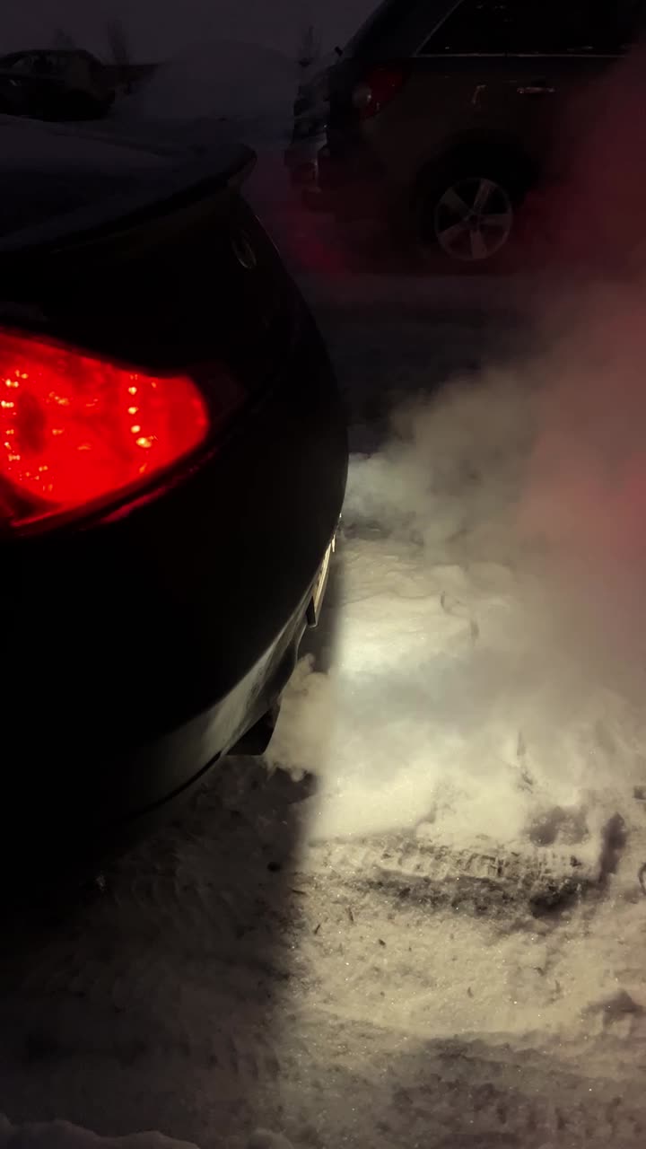 Car emitting smoke in snowy conditions