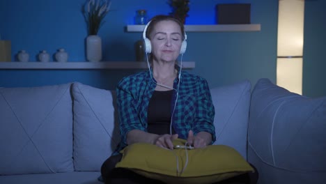 Woman-dancing-at-night-while-listening-to-music-at-home.