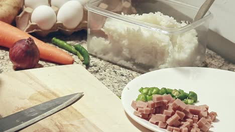 slicing and deseeding a red paprika on a kitchen counter showing a candid moment of home cooking and simple daily life