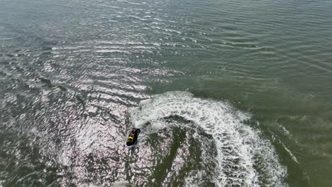 An-aerial-view-over-Gravesend-Bay-in-Brooklyn,-NY-as-a-jet-ski-rider-enjoys-the-sunny-day