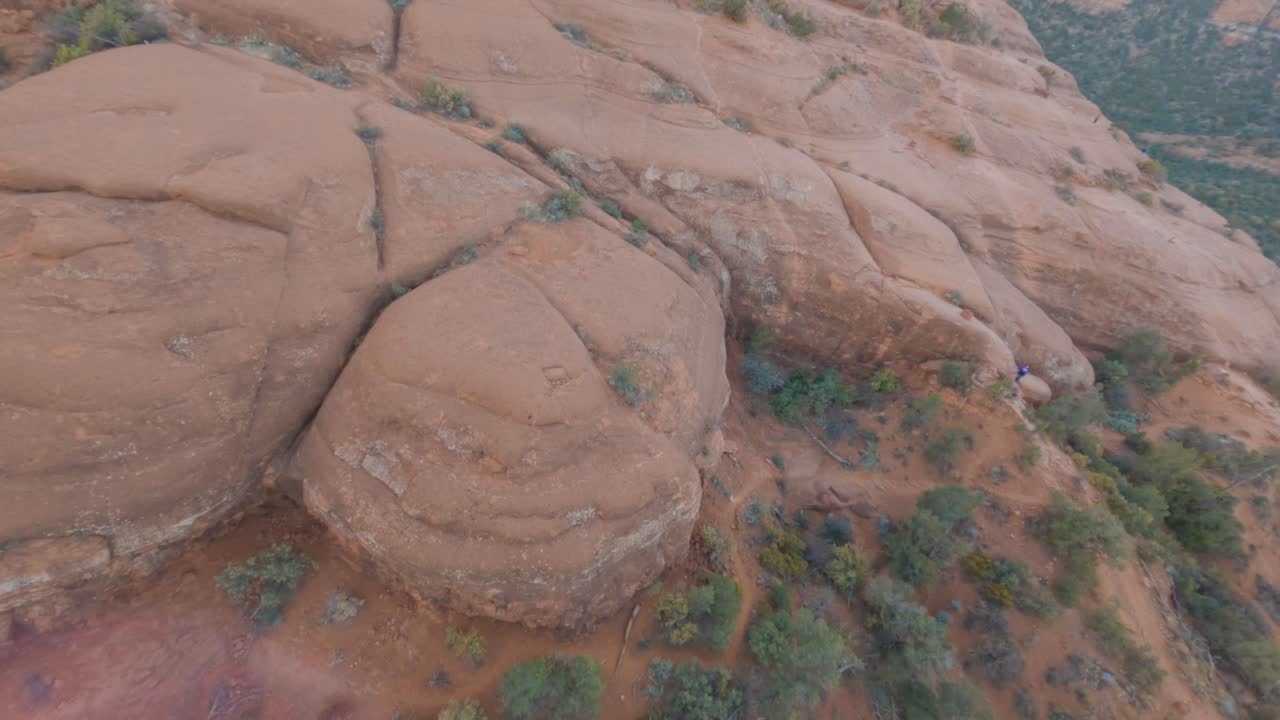 Ascending aerial shot of Bell Rock butte, Arizona.  Sunbeam and flares.