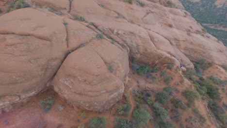 ascending aerial shot of bell rock butte, arizona.  sunbeam and flares.