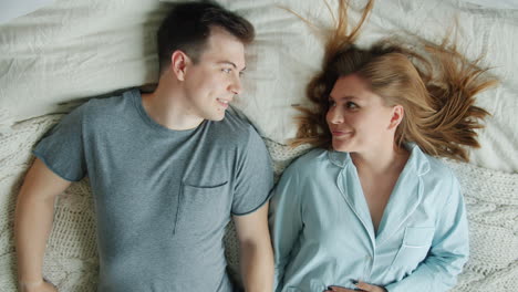 Happy Couple Lying in Bed