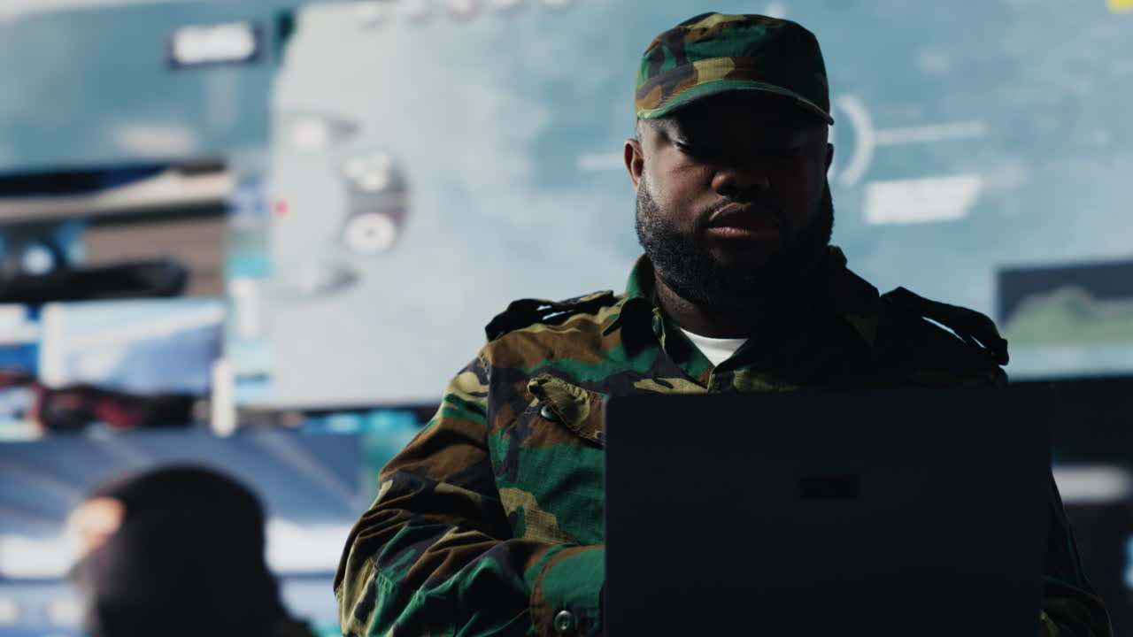 Defense forces officer reviews surveillance and digital systems