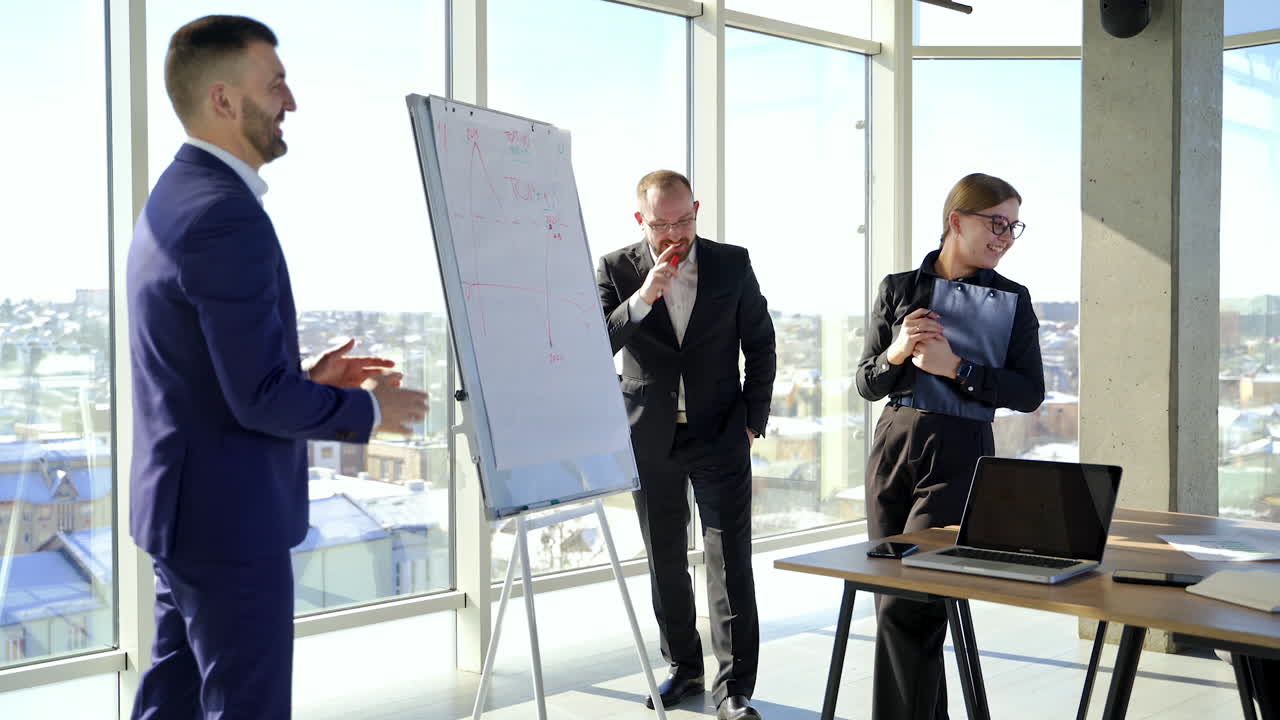Successful business people in the office centre in the city. Businessmen and women rejoicing about something while working about new project