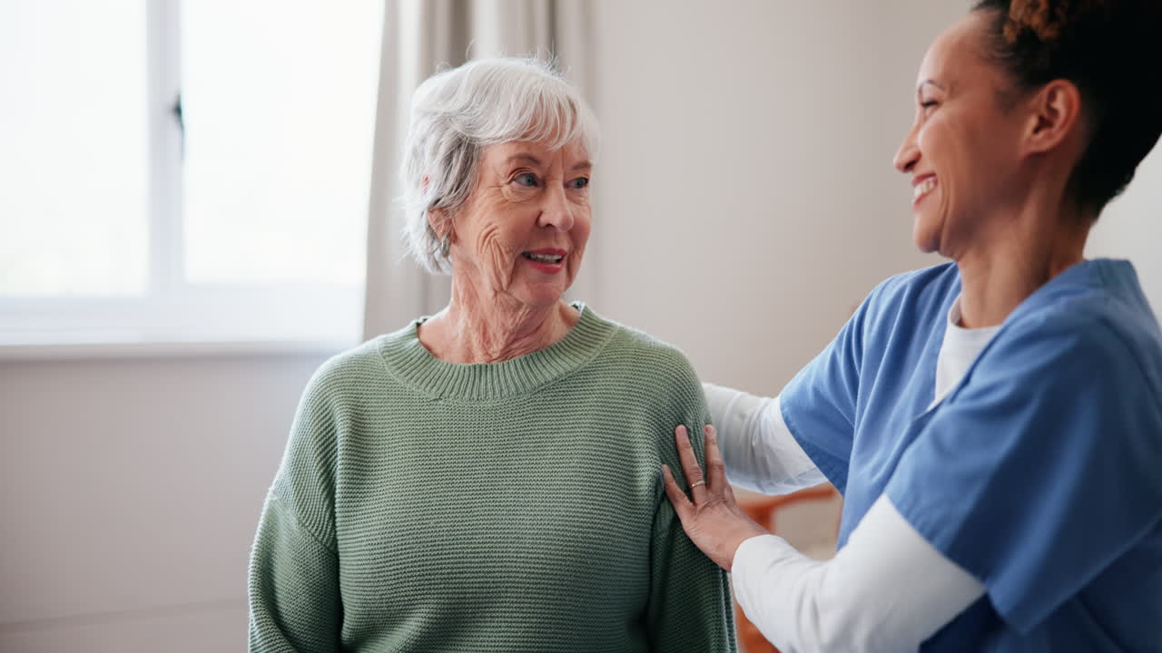 Caregiver assisting elderly woman with compassion and support