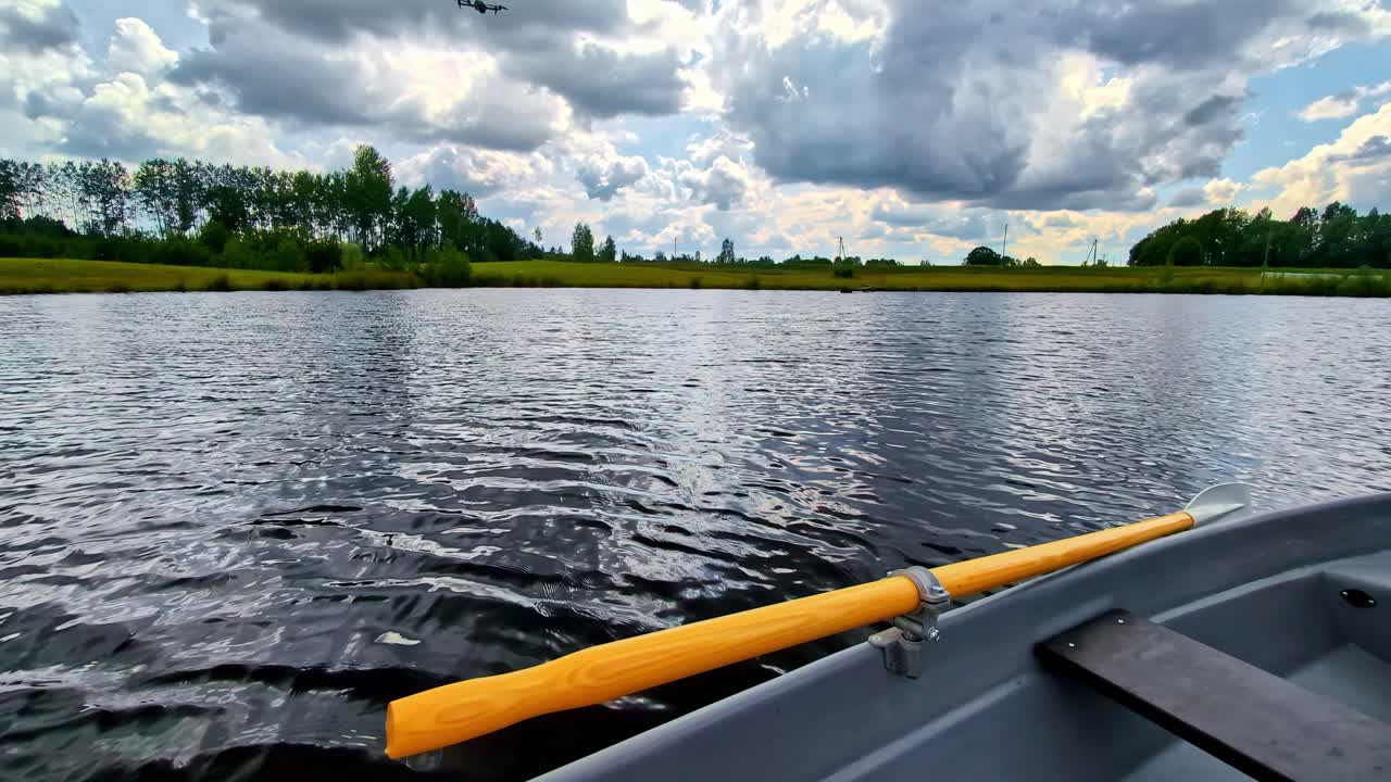 Point of view of paddling a canoe on a slow flowing river during a hot afternoon. Summer Sports. rowing kayak in Cesis, Latvia