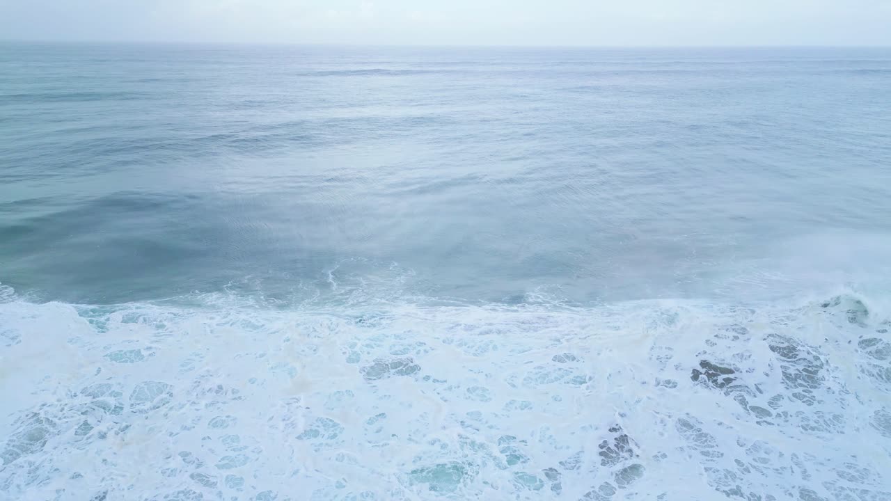 Waves crashing on the shore of Aljezur, Portugal, in a peaceful, serene moment