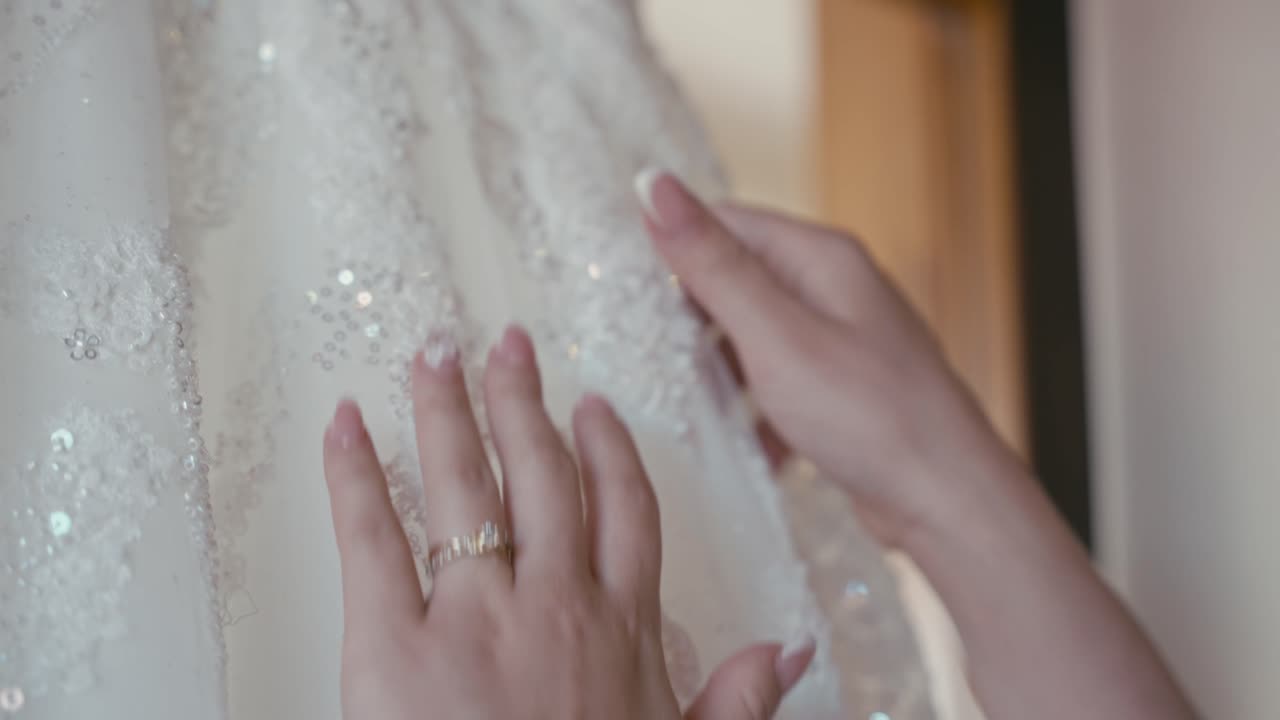 woman caressing wedding dress delicately
