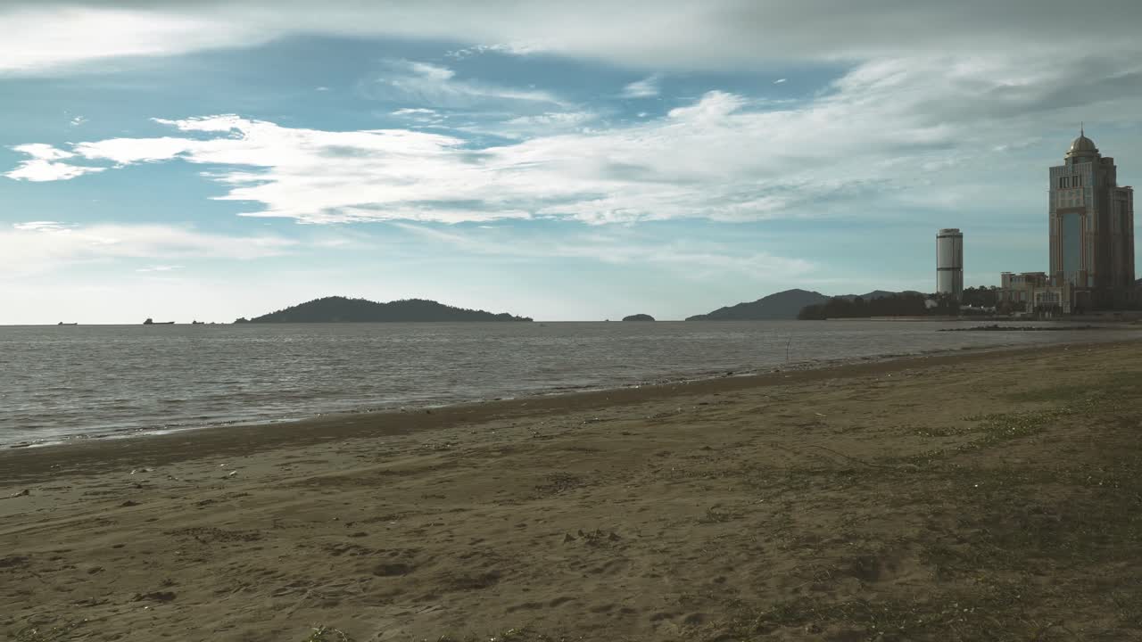 Summer Beautiful View Of Teluk Likas Beach, White Sandy Beach, Small Island, Blue sea water And Green Trees,Kota Kinabalu,Sabah,Malaysia.