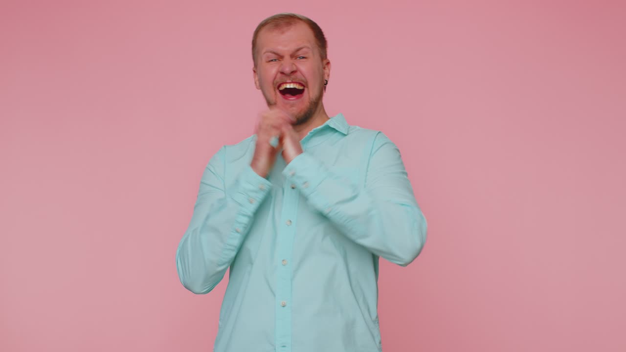 Joyful man laughing out loud after hearing ridiculous anecdote funny joke feeling carefree amused