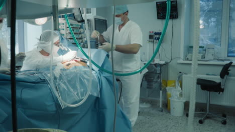 doctor applies patch strip during heart surgery in room. cardiologist team conducts coronary artery bypass surgery to ill patient in hospital