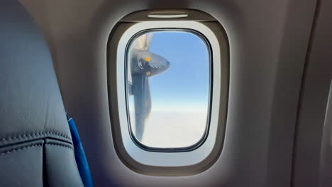 rotating propeller on a small airplane in the air, from a plane window