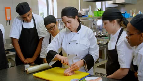 chef cutting meat on chopping board in kitchen 4k