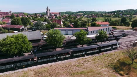 arriving at martel station, the steam train belches smoke