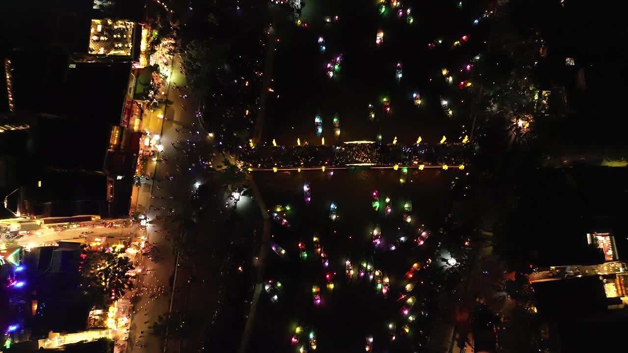 Brightly lit lanterns along the river in Hoi An, Vietnam, showcasing a vibrant night scene