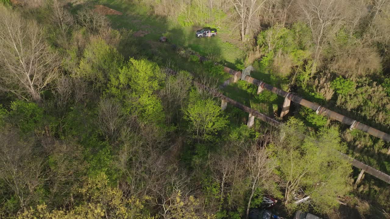 Bird's eye view of abandoned vehicles in Junk yard, abandoned area, circle pan