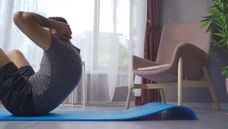 Athlete-man-doing-sit-ups-training-at-home.