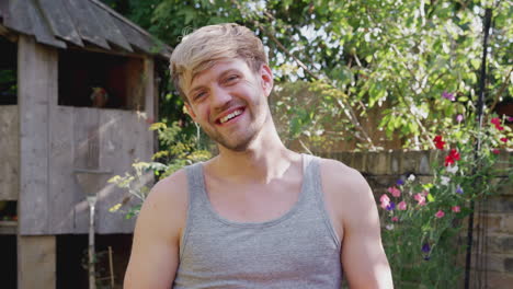 Portrait-Of-Smiling-Man-At-Home-In-Garden-Against-Flaring-Sun