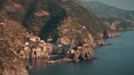 aerial orbit right vernazza, cinque terre, italy, iconic cliffside village and ocean vista at sunset