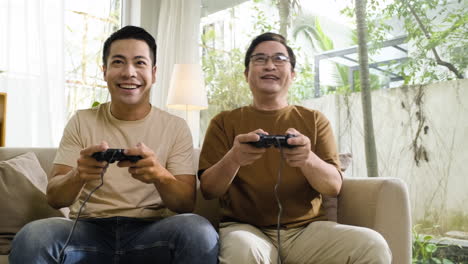 senior and young asian men in the living room