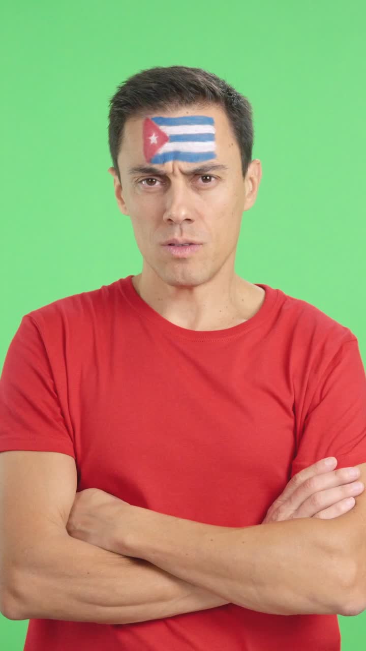 Dignified and serious man with cuban flag painted on face