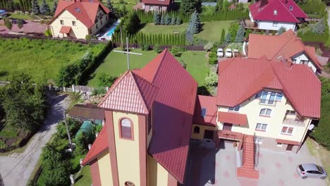 Aerial-shot-of-a-small-church-with-a-a-cross-on-top