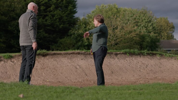 Golfers at a sand bunker on a golf course