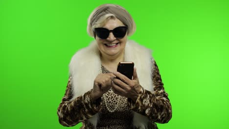 Elderly-stylish-trendy-caucasian-grandmother-woman-using-smartphone.-Chroma-key